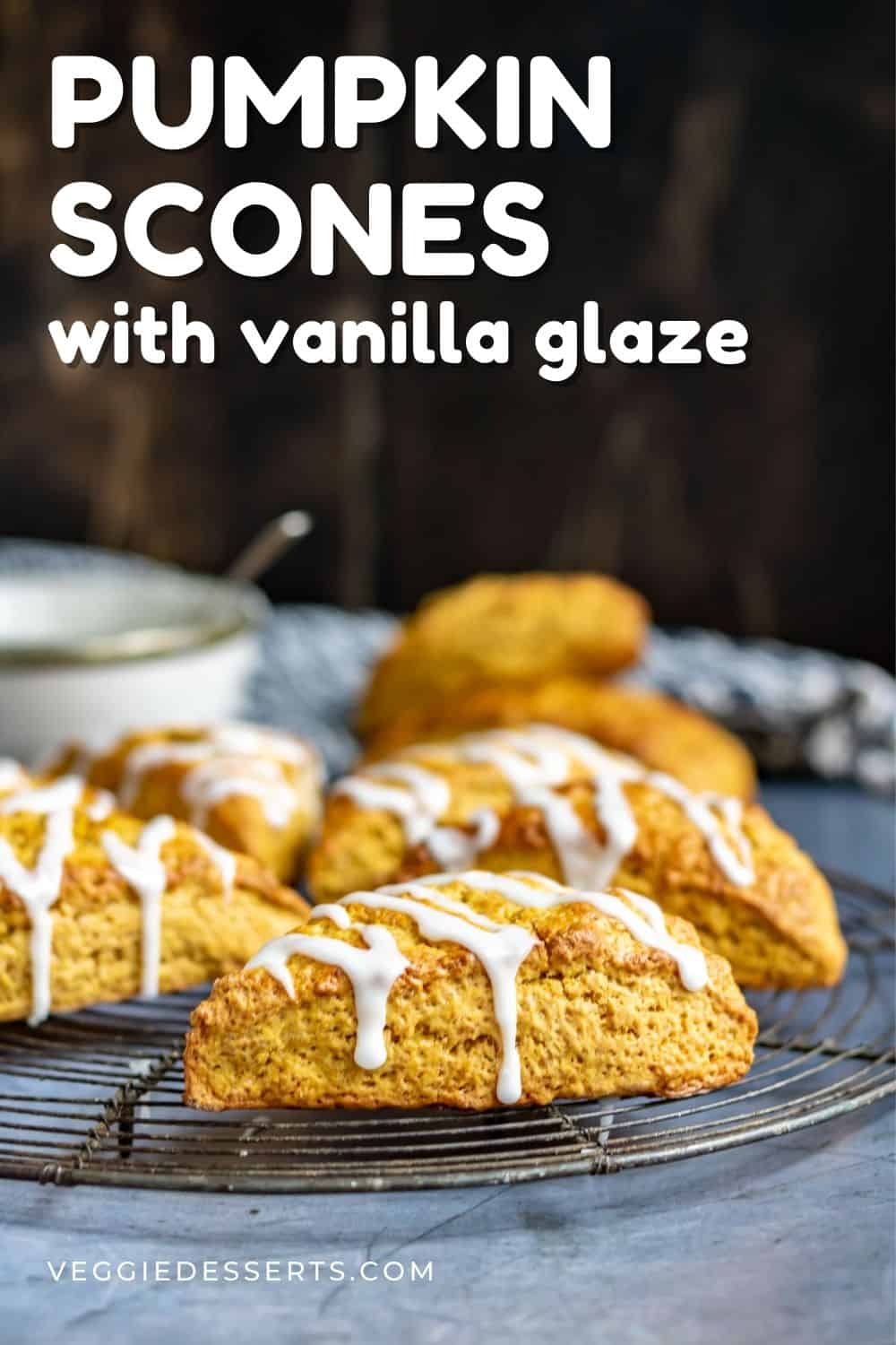 Scones on a rack, with text: Pumpkin Scones with Vanilla Glaze.
