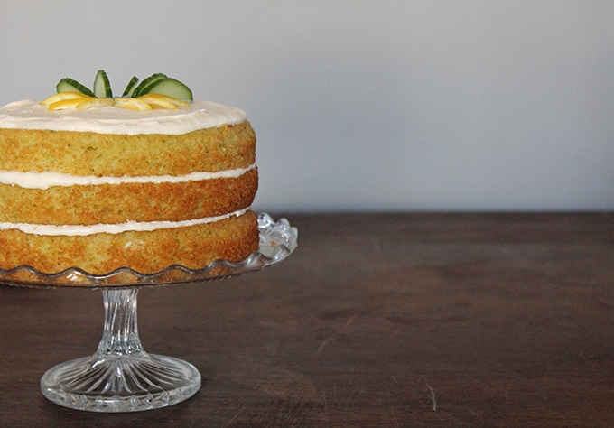 A Lemon and Cucumber Cake with Gin Icing on a vintage glass cake stand