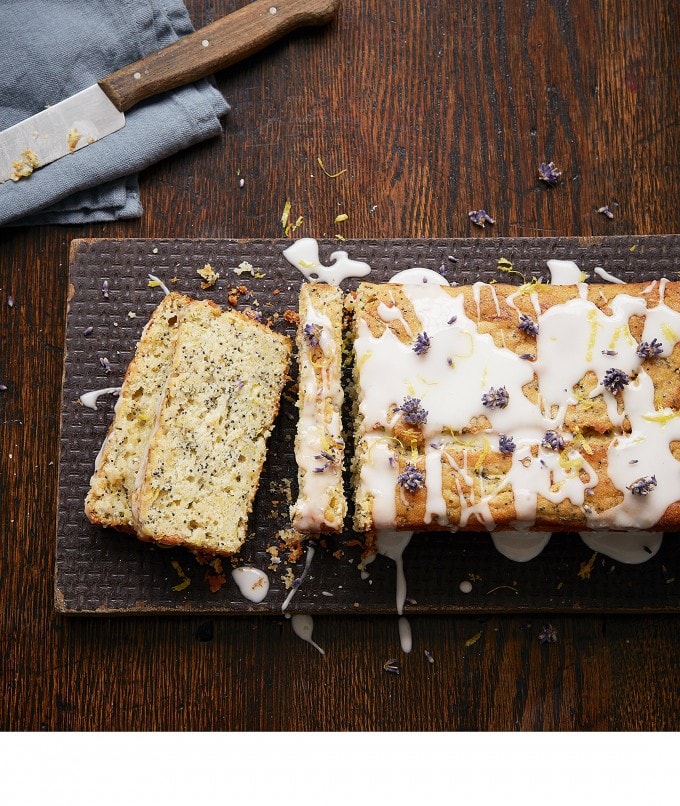 Loaf cake on a board next to a knife.