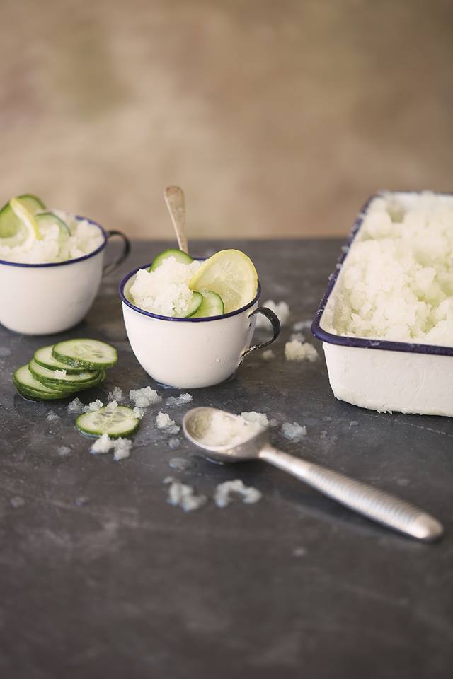 Mugs of frozen cucumber granita on a table.