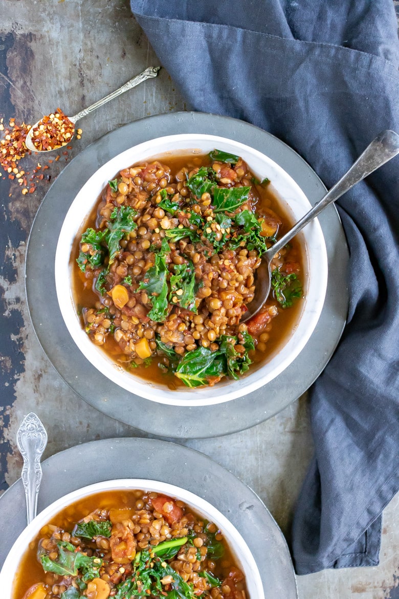 Overhead shot of two bowls of easy slow cooker lentil stew (vegan recipe).