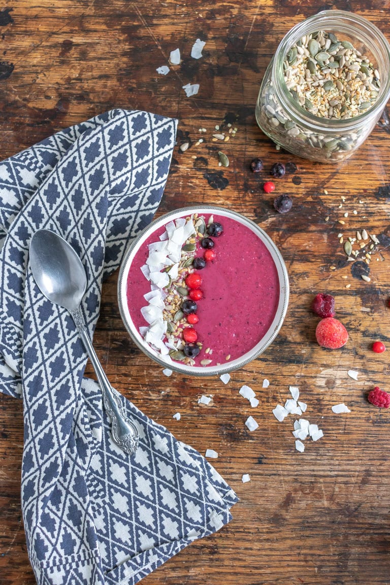 Table with smoothie in a bowl.
