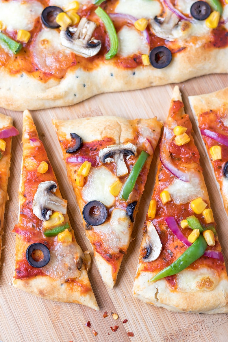 Close up overhead shot of slices of naan bread pizza