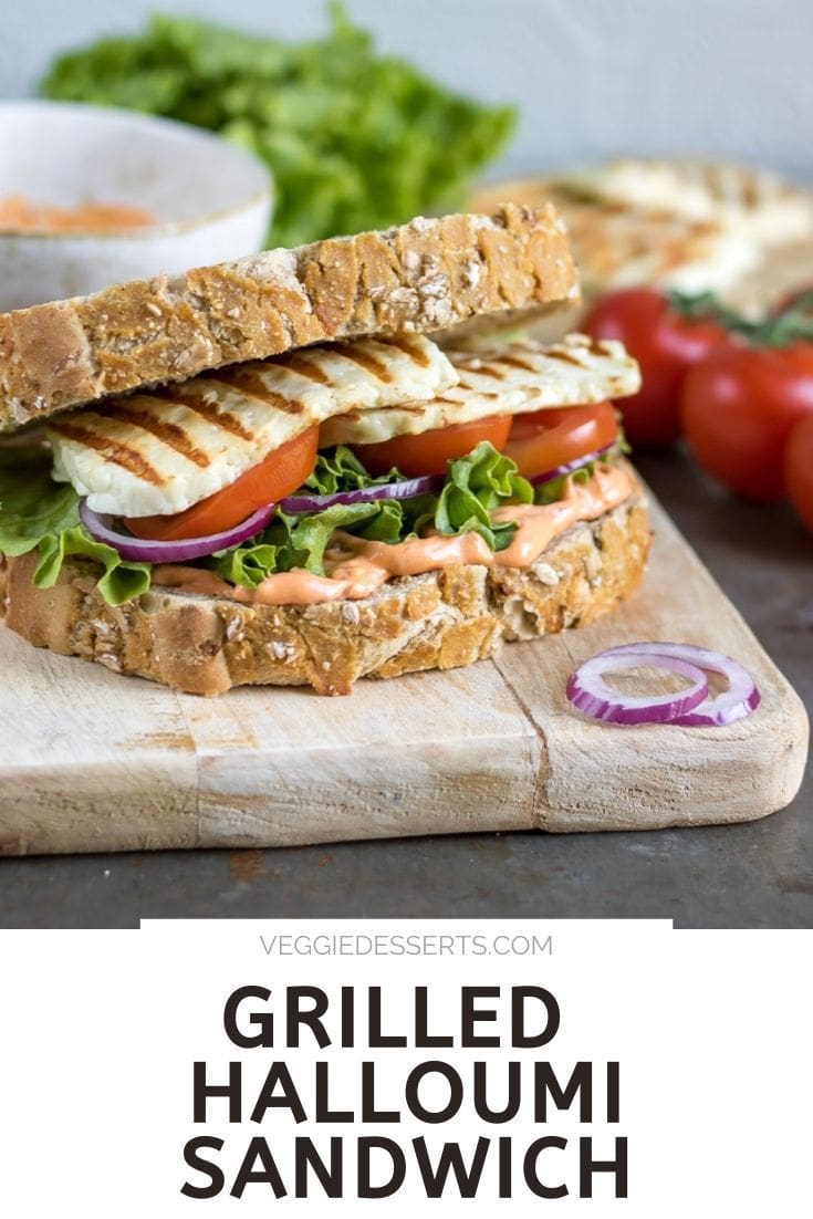 Sandwich on a board, with text: Grilled Halloumi Sandwich.