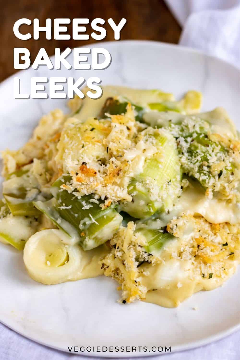 Plate with a serving of cheesy leeks, with text overlay: cheesy baked leeks.