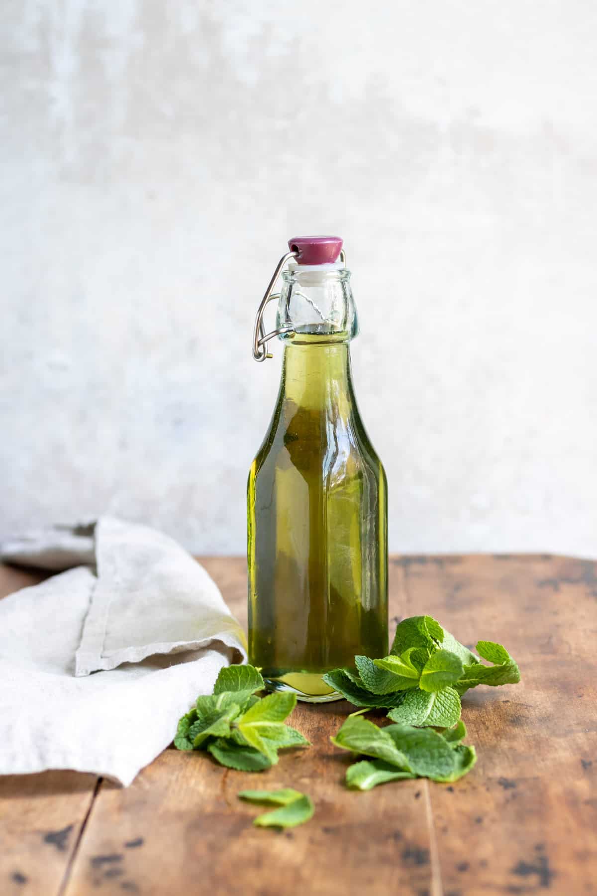 Bottle of mint syrup on a table.
