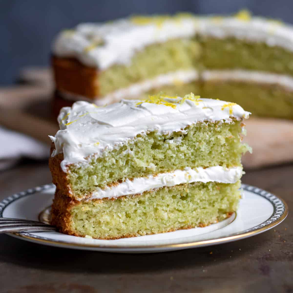 A slice of lemon cucumber cake on a plate.