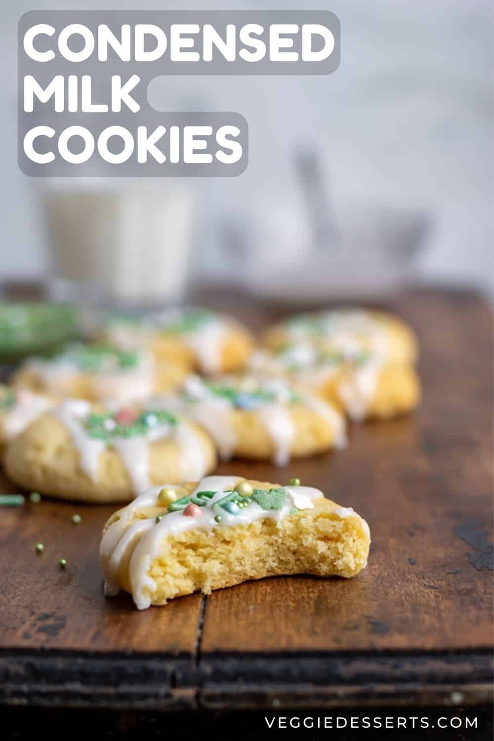 Cookie with a bite out on a table, with text: Condensed Milk Cookies.