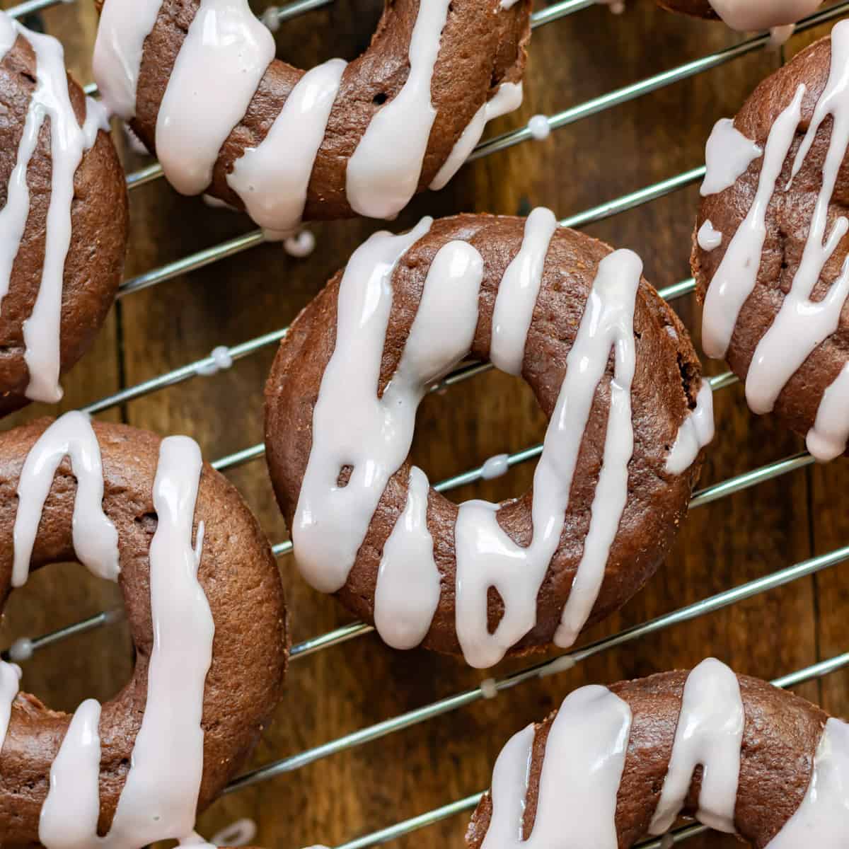 Close up of baked beet chocolate donuts on a wire rack.